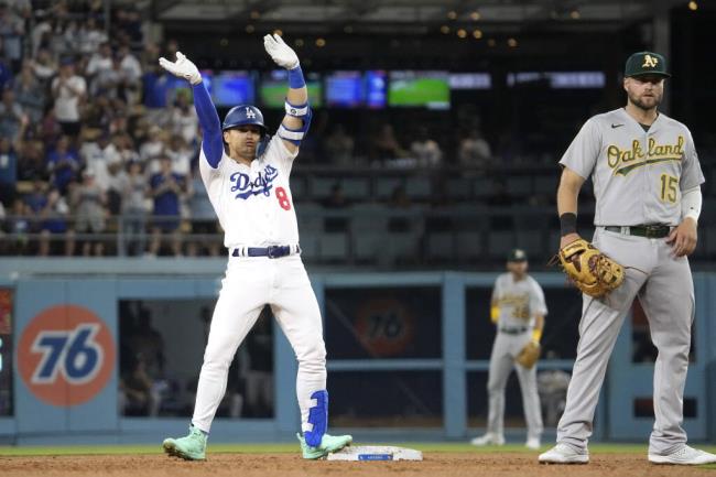 Dodgers shortstop Kiké Hernández, left, celebrates after hitting a three-RBI double during the fourth inning against the Oakland Athletics Tuesday, Aug. 1, 2023, in Los Angeles. (Mark J. Terrill / ASSOCIATED PRESS)