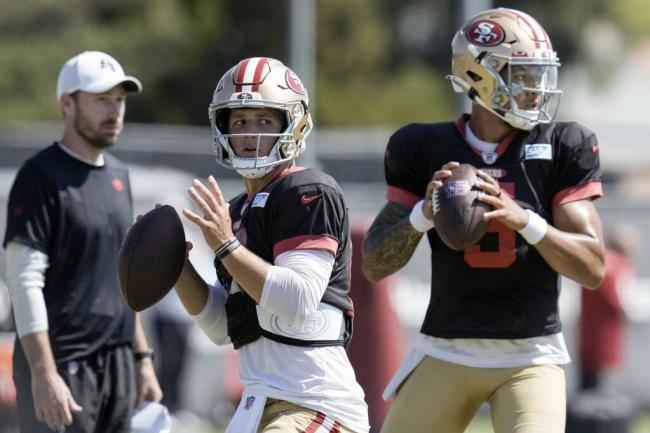 49ers quarterback Brock Purdy, left, takes part in a drill during training camp Friday, Aug. 4, 2023, in Santa Clara. (Godofredo A. Vásquez / ASSOCIATED PRESS)